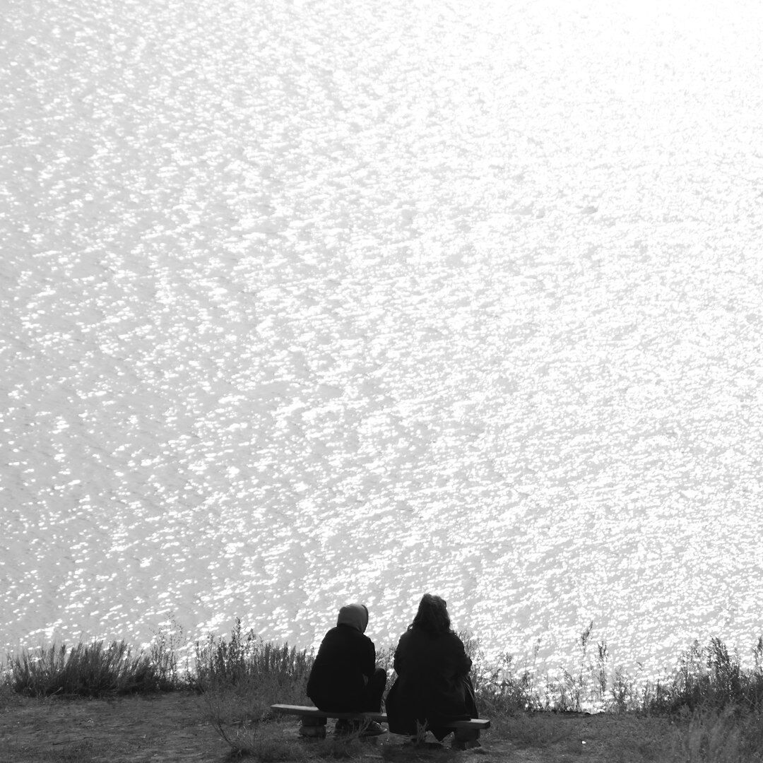 Two people having a supportive conversation outdoors