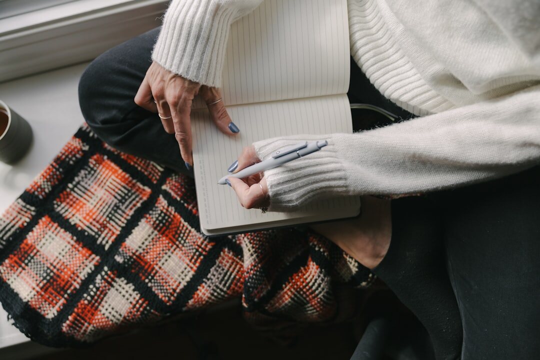 person writing in notebook